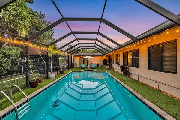 a view of a backyard with a swimming pool