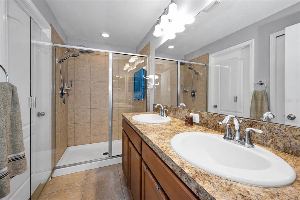 9736 Trumpet Vine Loop Trinity, FL 34655 - Photo 7 of 35 a bathroom with a sink double vanity and shower