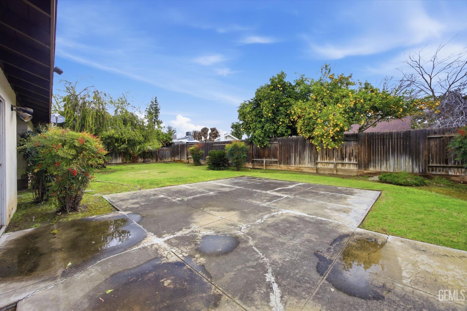 Undisclosed Address Bakersfield, CA 93309 - Photo 2 of 41 a view of a yard with plants and a tree