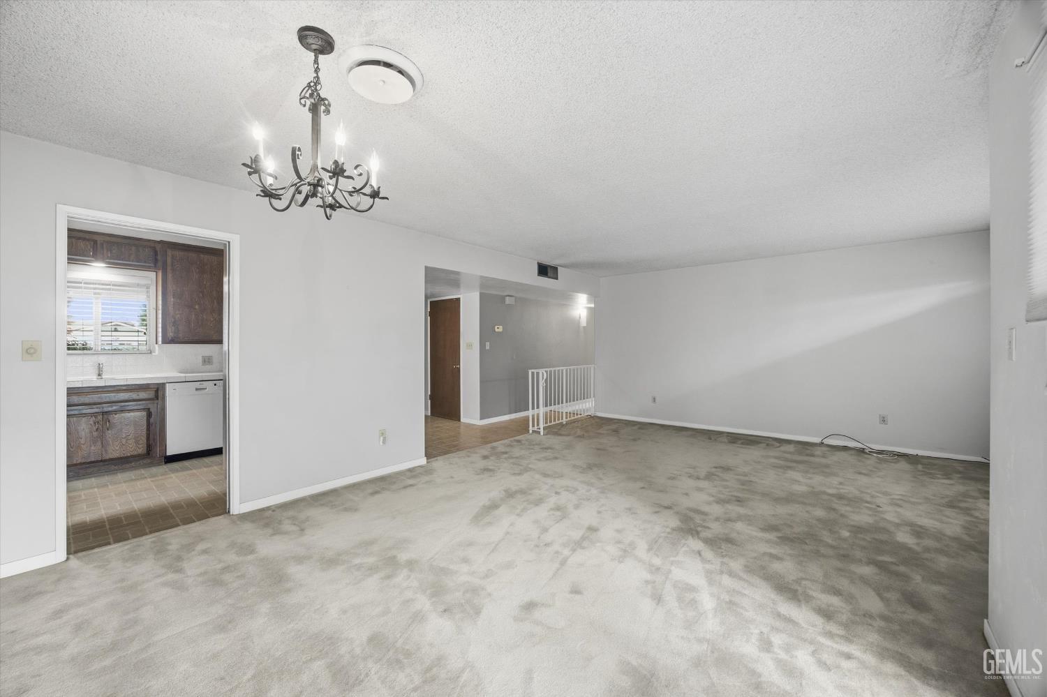 Undisclosed Address Bakersfield, CA 93309 - Photo 24 of 41 a view of a room with a chandelier and kitchen view