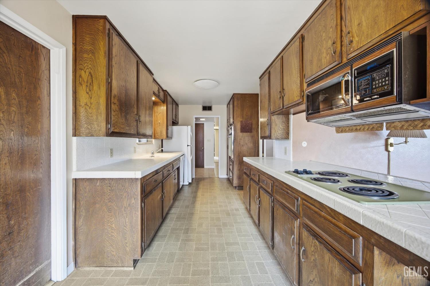 Undisclosed Address Bakersfield, CA 93309 - Photo 31 of 41 a kitchen with stainless steel appliances a sink stove and cabinets