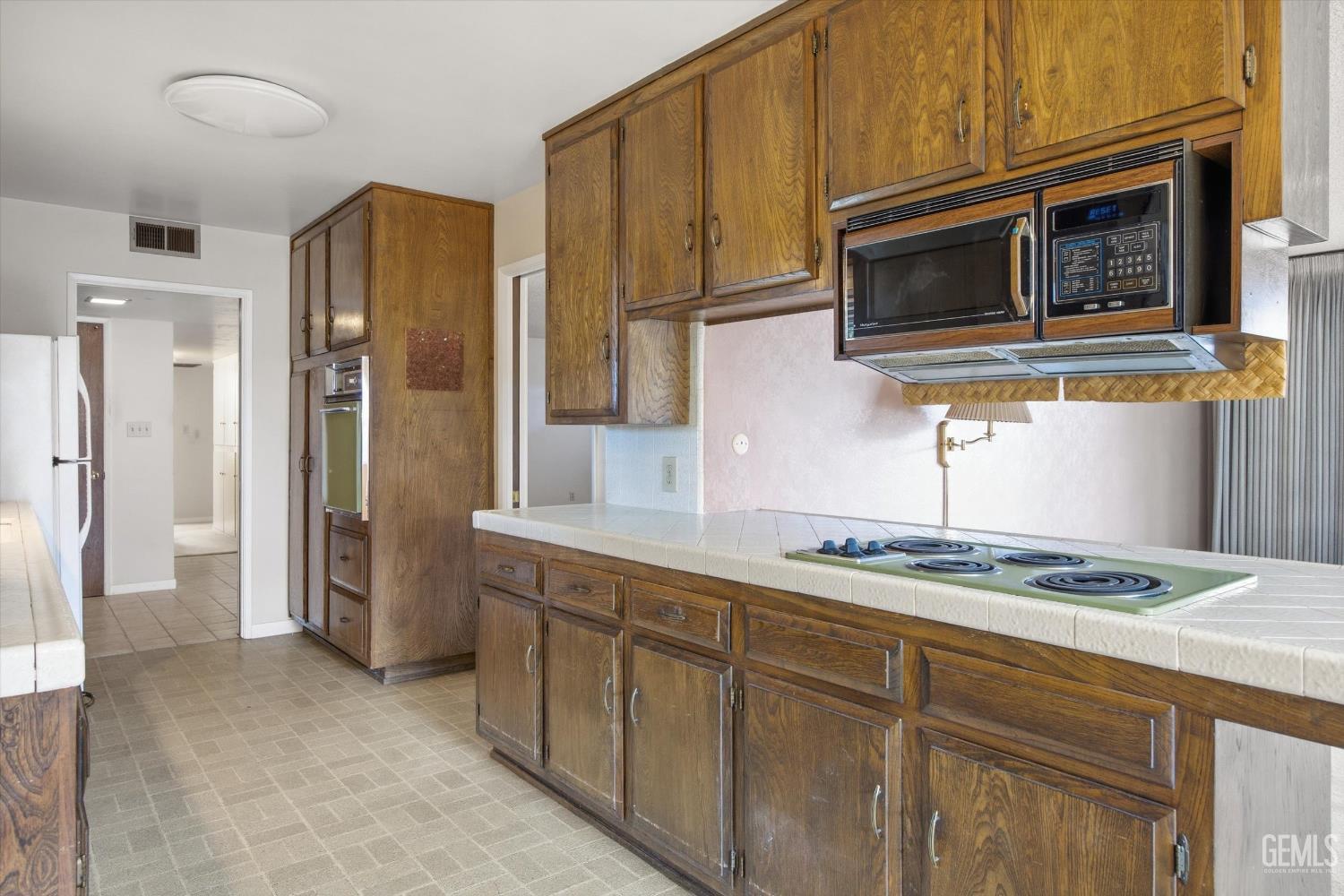 Undisclosed Address Bakersfield, CA 93309 - Photo 33 of 41 a kitchen with stainless steel appliances granite countertop a refrigerator and microwave
