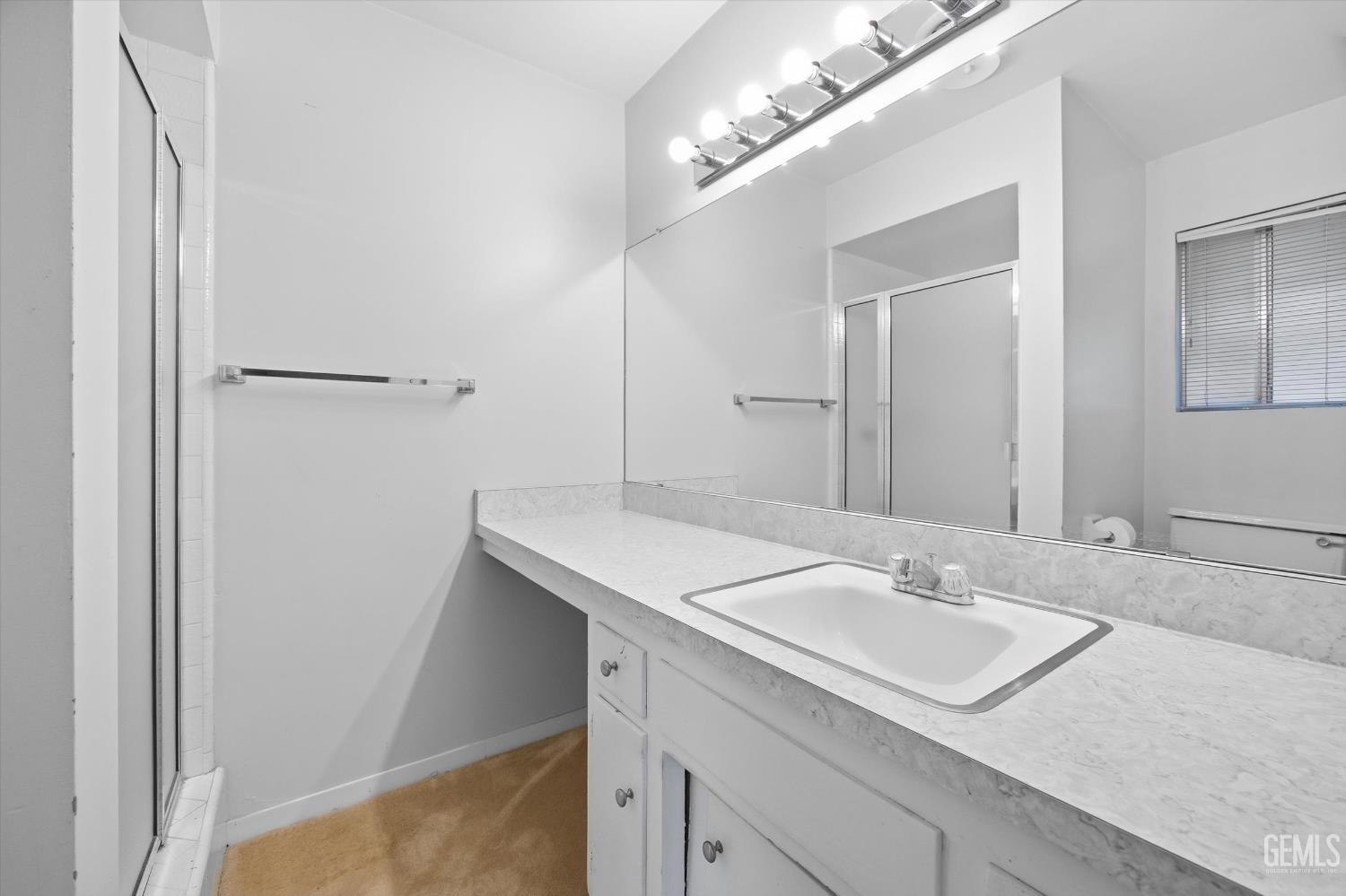 Undisclosed Address Bakersfield, CA 93309 - Photo 40 of 41 a bathroom with a sink and a mirror