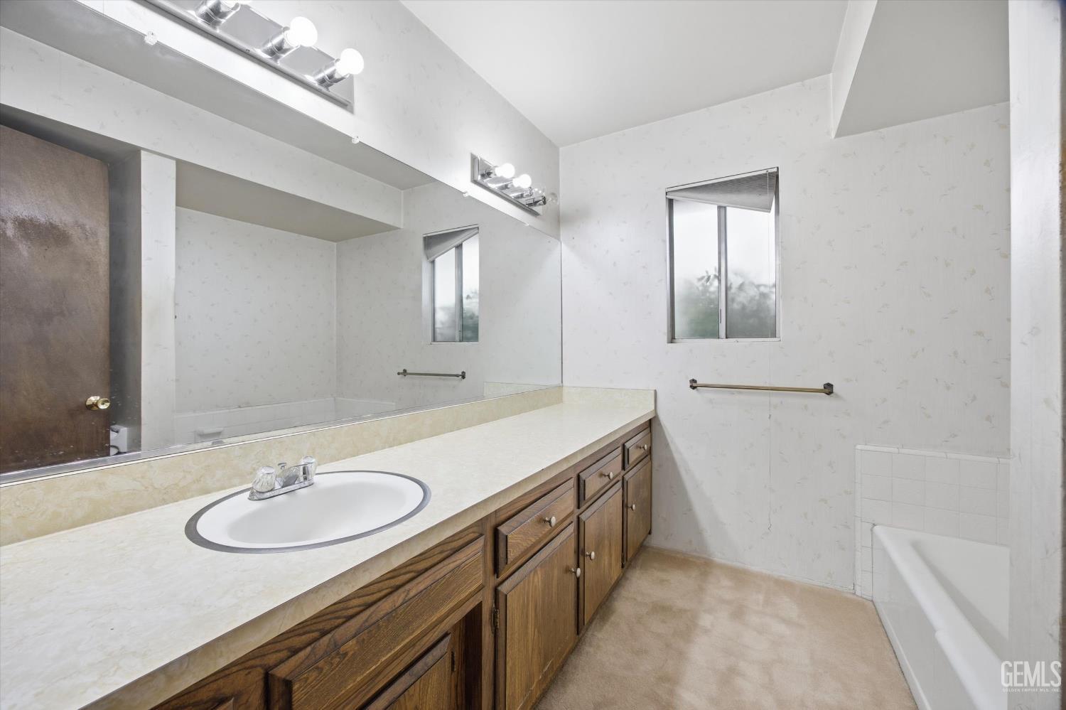Undisclosed Address Bakersfield, CA 93309 - Photo 10 of 41 a bathroom with a sink double vanity and a mirror
