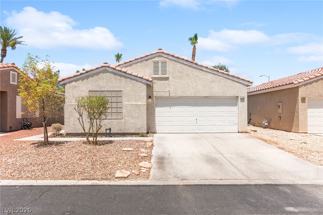 7353 Ridge Star Court Las Vegas, NV 89131 - Photo 1 of 36 A well-maintained stucco home with an attached garage offers a welcoming facade and low-maintenance landscaping.