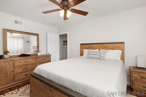 a bedroom with a large bed and a chandelier