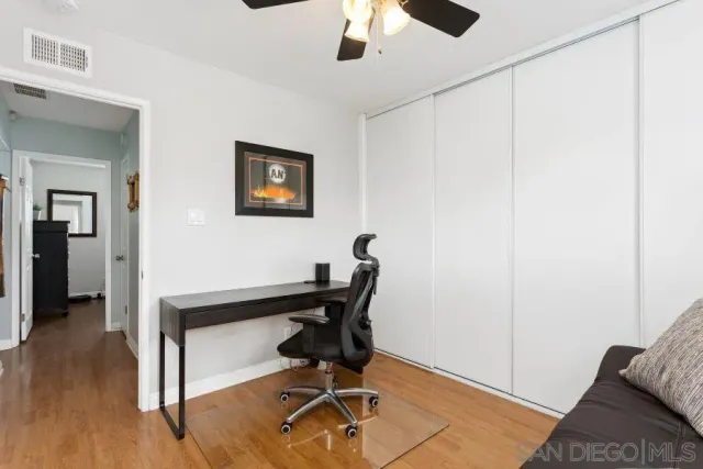 a view of a workspace with furniture and wooden floor