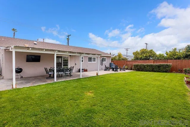 a view of a house with a backyard porch and sitting area
