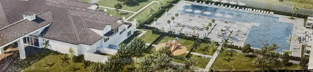 a backyard of a house with table and chairs under an umbrella