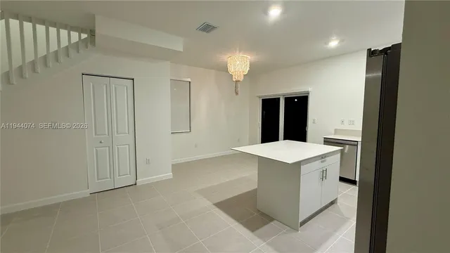 a view of kitchen cabinets and white appliances