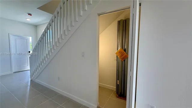 a view of a hallway with wooden floor and entryway