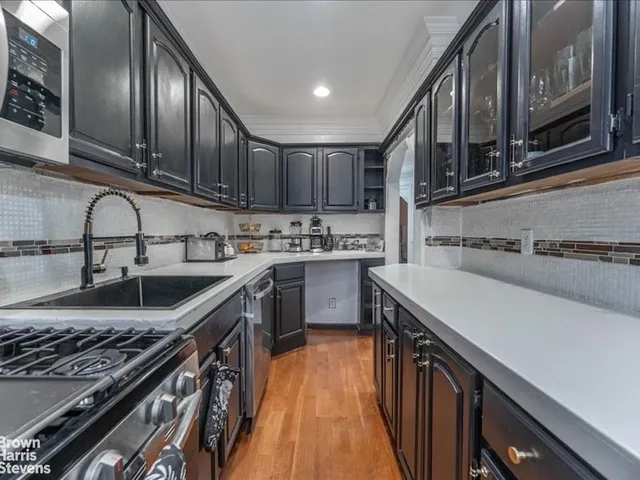 a kitchen that has a sink and a stove