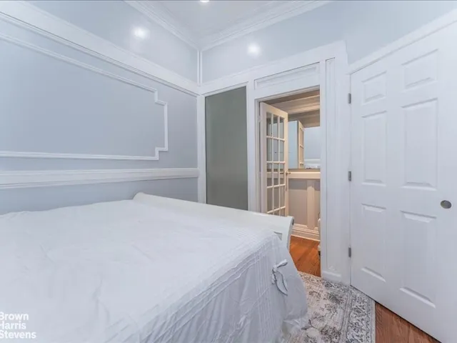 a spacious bedroom with a bed and a sink