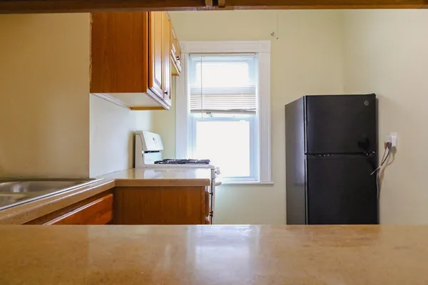 a kitchen with a refrigerator and a sink