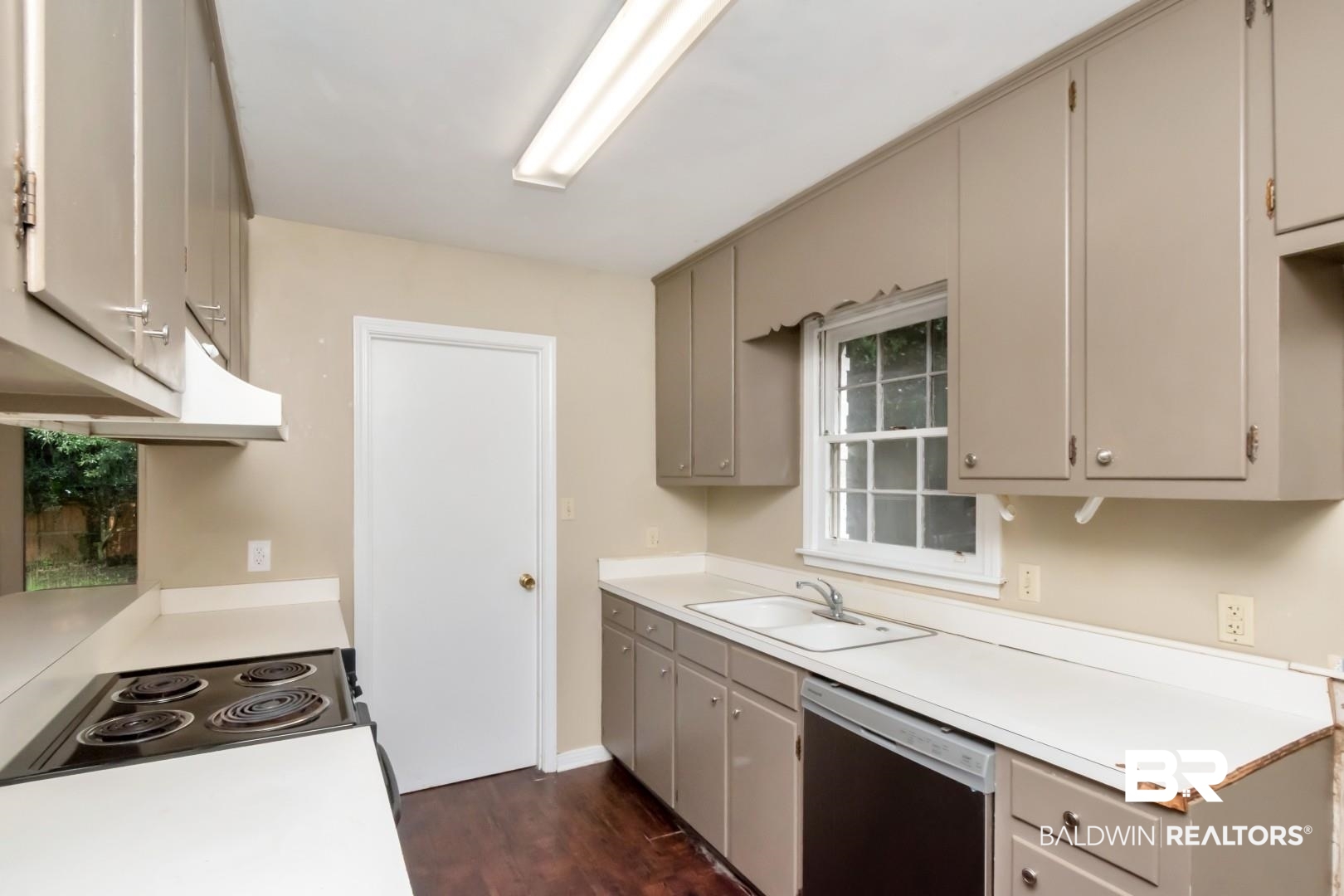 324 Judson Drive Mobile, AL 36608 - Photo 8 of 20 Kitchen featuring gray cabinetry, white dishwasher, dark wood-style floors, and light countertops