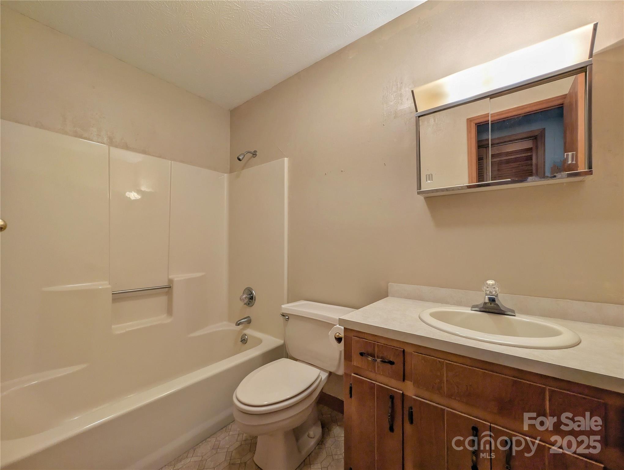 84 Stoney Ridge Loop Maggie Valley, NC 28751 - Photo 23 of 27 a bathroom with a sink toilet and shower