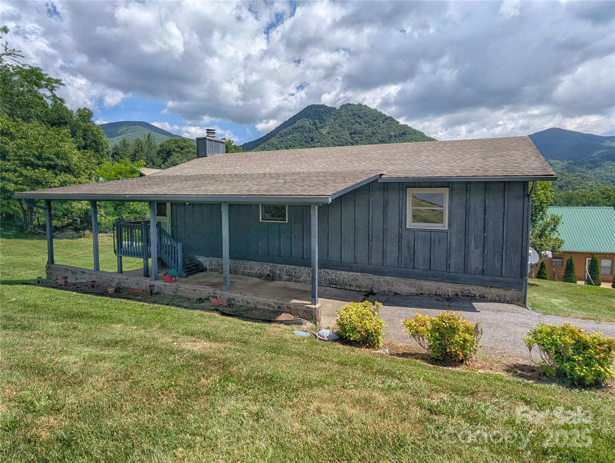 84 Stoney Ridge Loop Maggie Valley, NC 28751 - Photo 8 of 27 a view of a house with backyard and sitting area