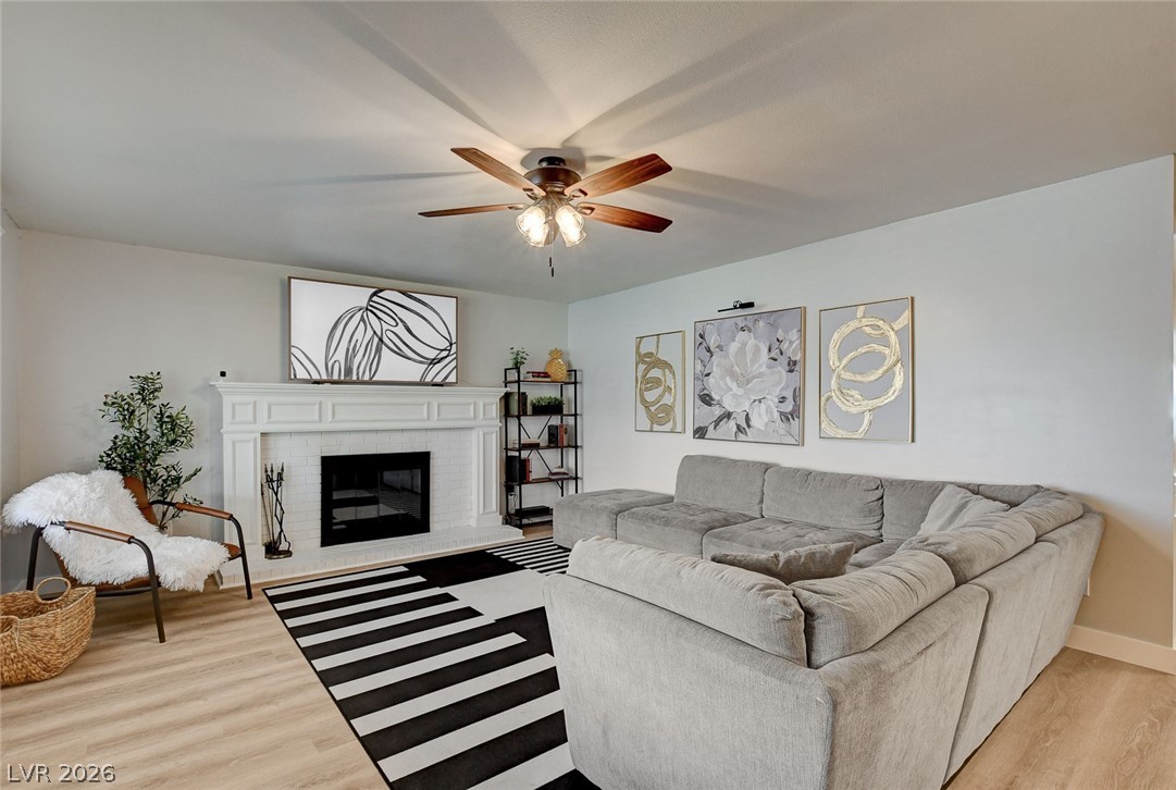 3765 Berkeley Street Logandale, NV 89021 - Photo 2 of 87 This inviting living space features a cozy fireplace, light flooring, and comfortable seating, perfect for daily living.