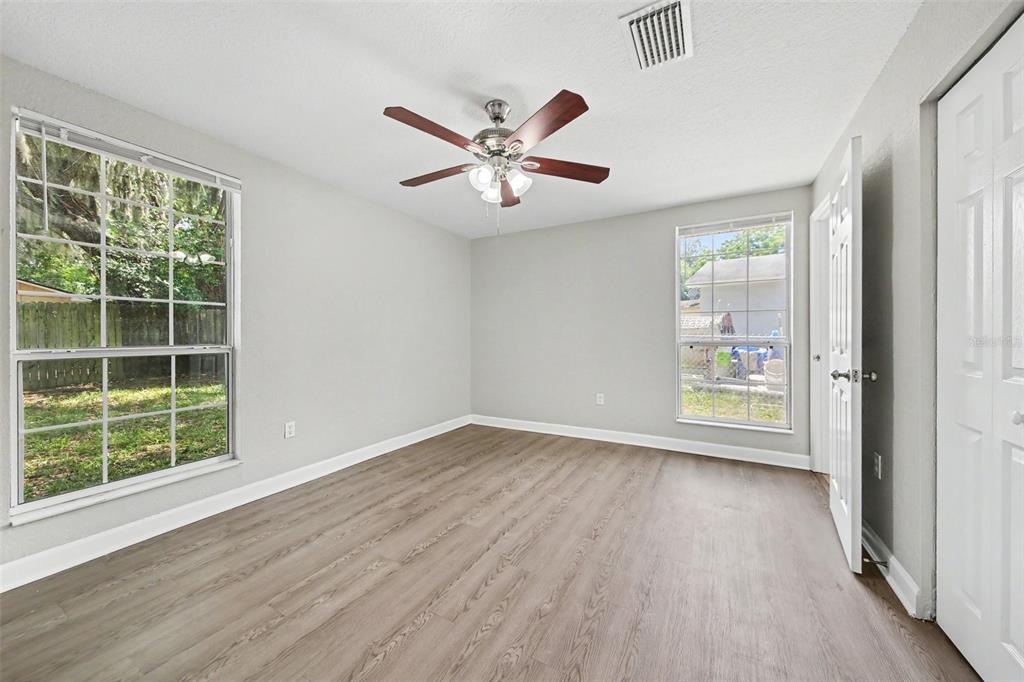 1109 Inland Street Leesburg, FL 34748 - Photo 8 of 15 a view of an empty room with wooden floor and a window