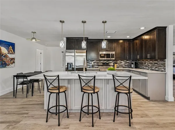 a kitchen with cabinets and stainless steel appliances