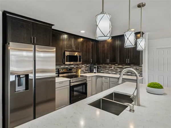 a kitchen with sink cabinets and stainless steel appliances