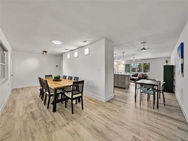 a view of a room with furniture and wooden floor