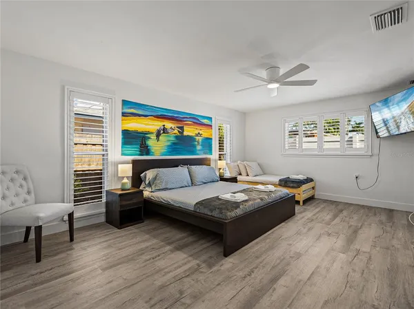 a bedroom with a bed and a window