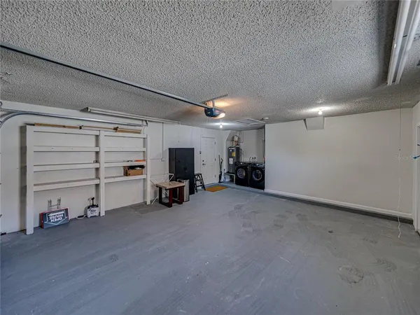 a view of a backyard with plants and a patio