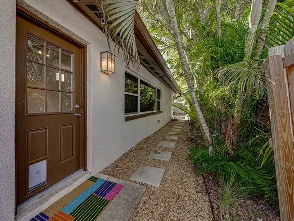 a view of backyard with wooden fence and a large tree