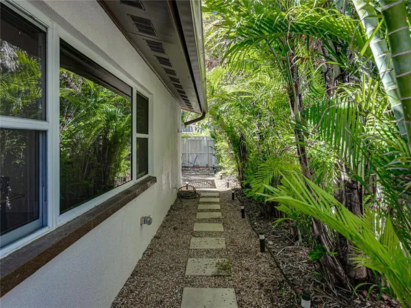 a view of a house with backyard and sitting area