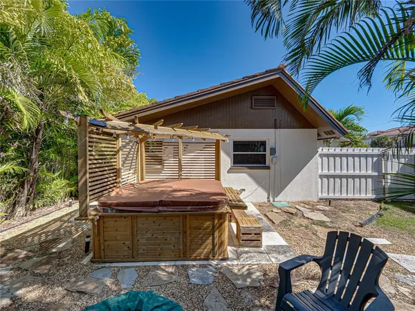 a view of a backyard with wooden fence
