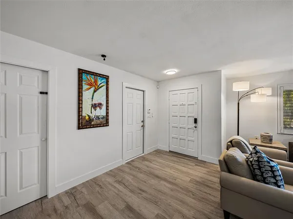 a living room with furniture a rug and a flat screen tv