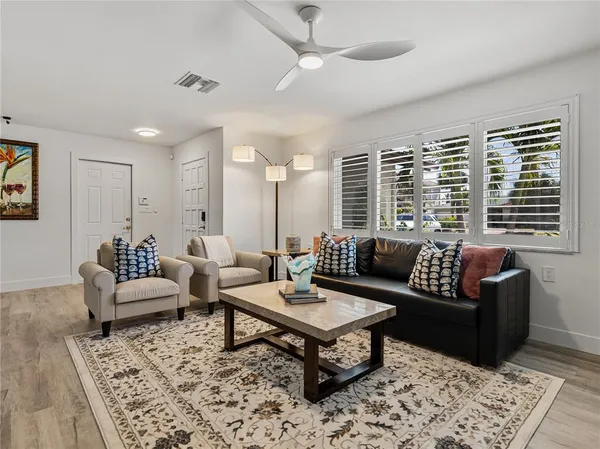a living room with furniture and view of kitchen
