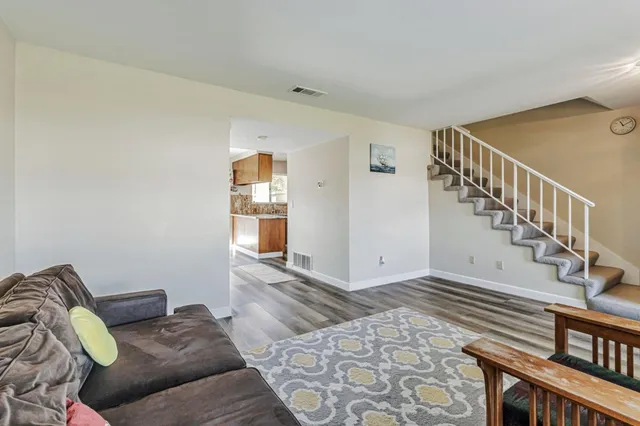 a living room with furniture and stairs