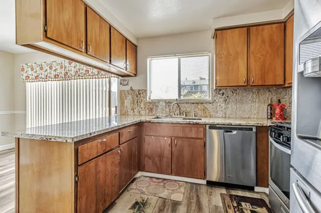 a kitchen with stainless steel appliances granite countertop a sink and a cabinets