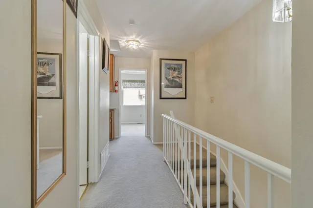 a view of a hallway with paintings on the wall