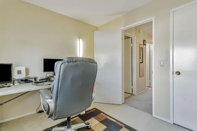 a view of a workspace with furniture and a flat screen tv