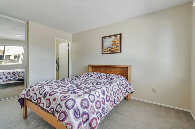 a bedroom with a bed and a lamp