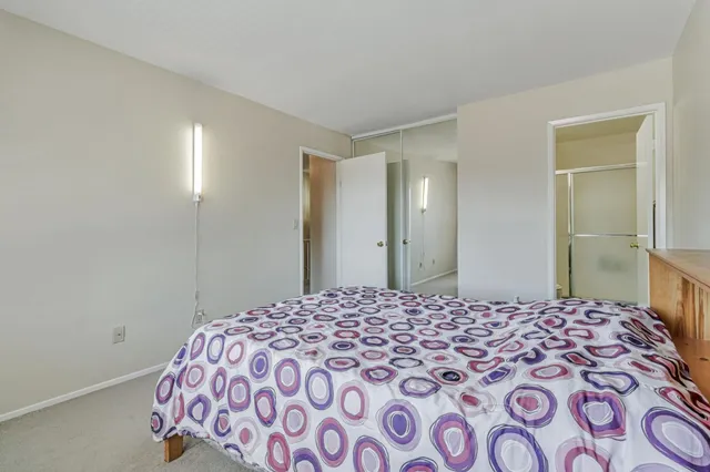 a bedroom with a large bed and a walk in closet