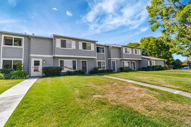 a front view of a building with a garden