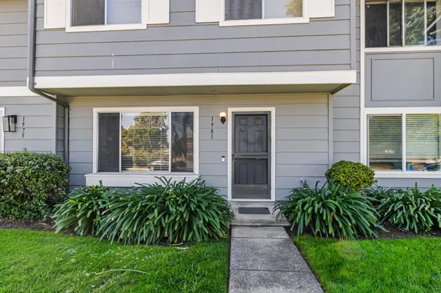 a view of a house with a small yard and plants