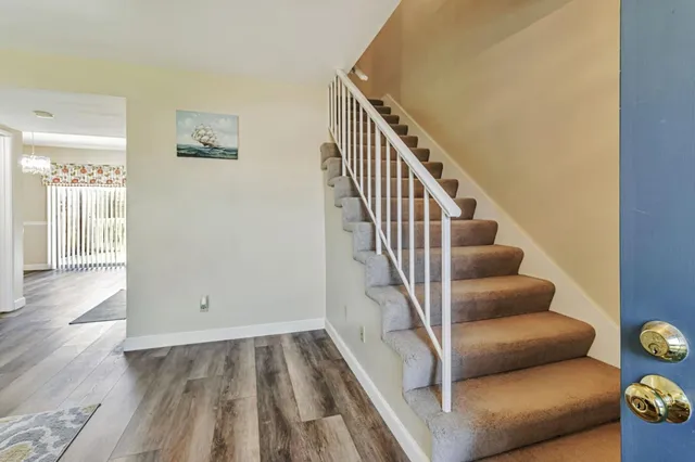 a view of entryway and workspace with wooden floor