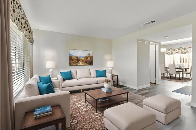 a living room with furniture and a large window