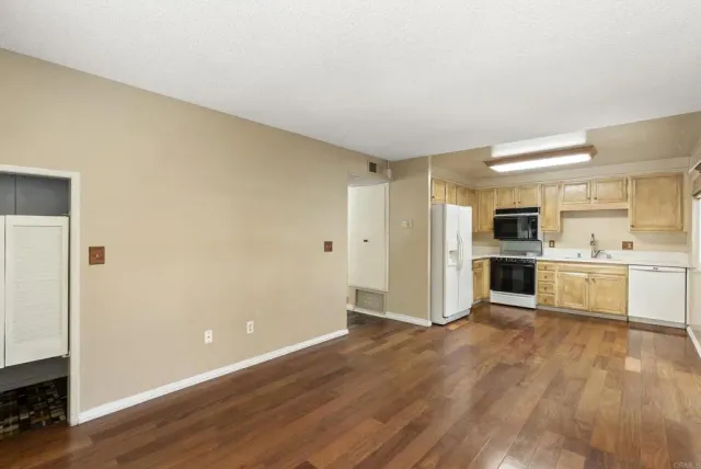 a view of a kitchen with wooden floor