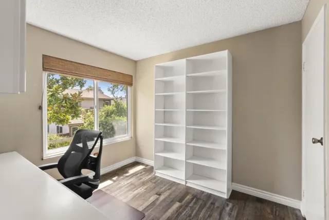 a view of a room with gym equipment and a large window
