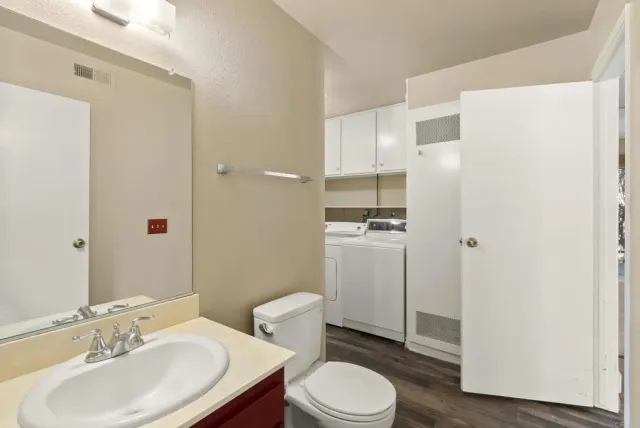 a bathroom with a toilet a sink and a mirror