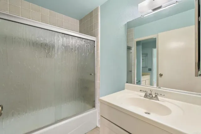 a bathroom with a bathtub and a sink