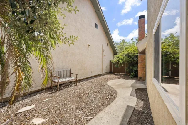 a view of house with backyard and sitting area