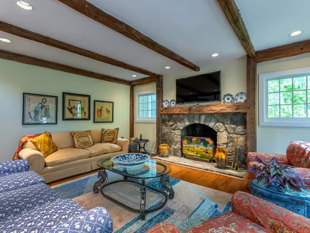 a living room with furniture fireplace and flat screen tv