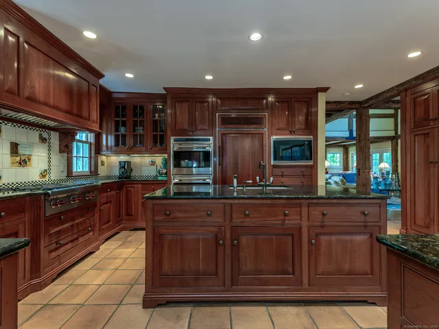 a kitchen with stainless steel appliances granite countertop a sink and cabinets